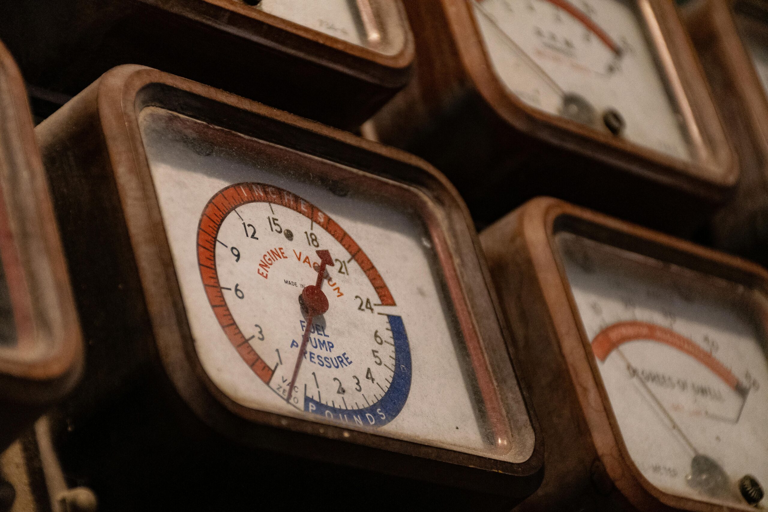Close-up of a collection of vintage vacuum gauges with a rusty, nostalgic appearance.